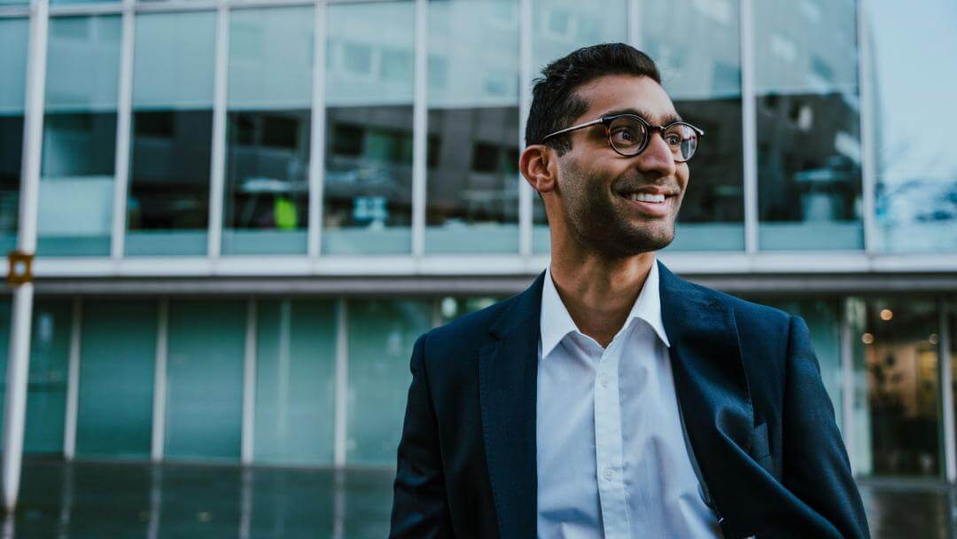 corporate man walking outside an office