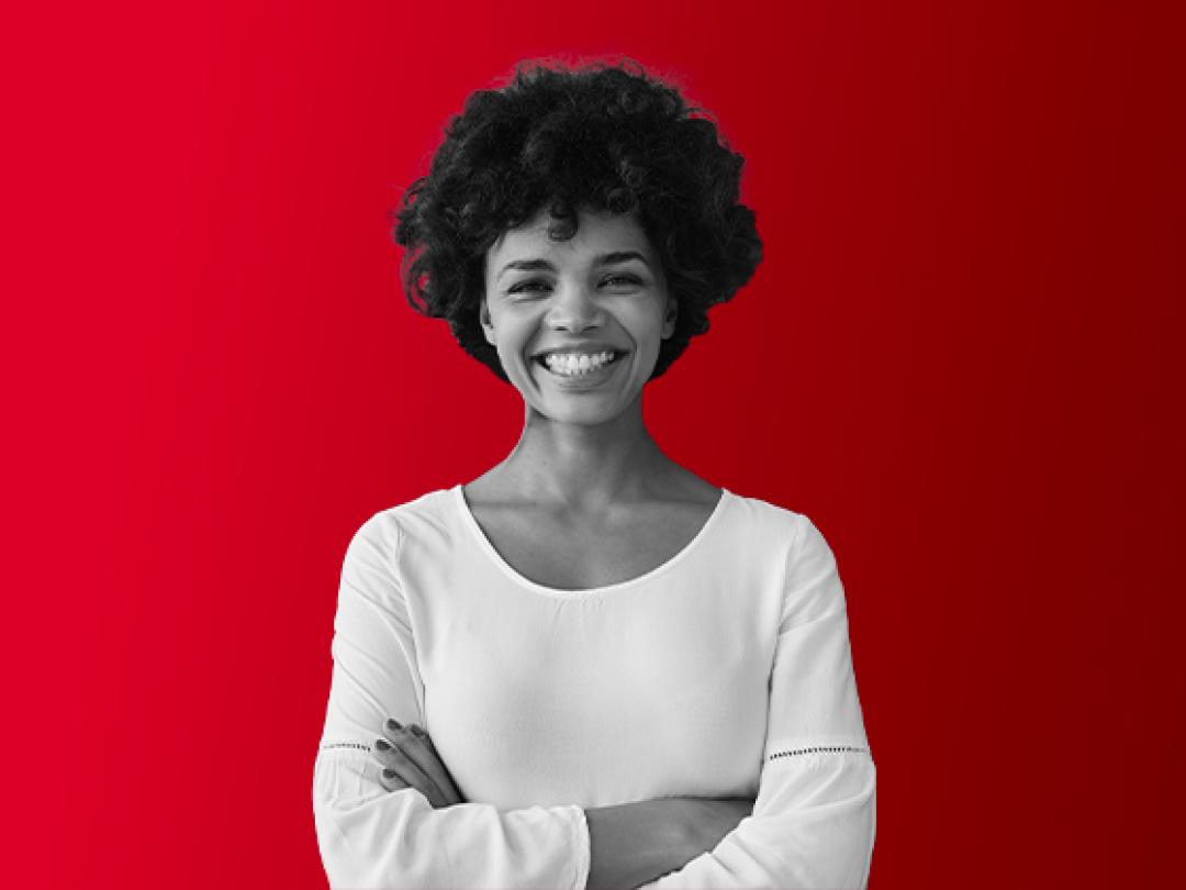 A lady crossing her arms, smiling.