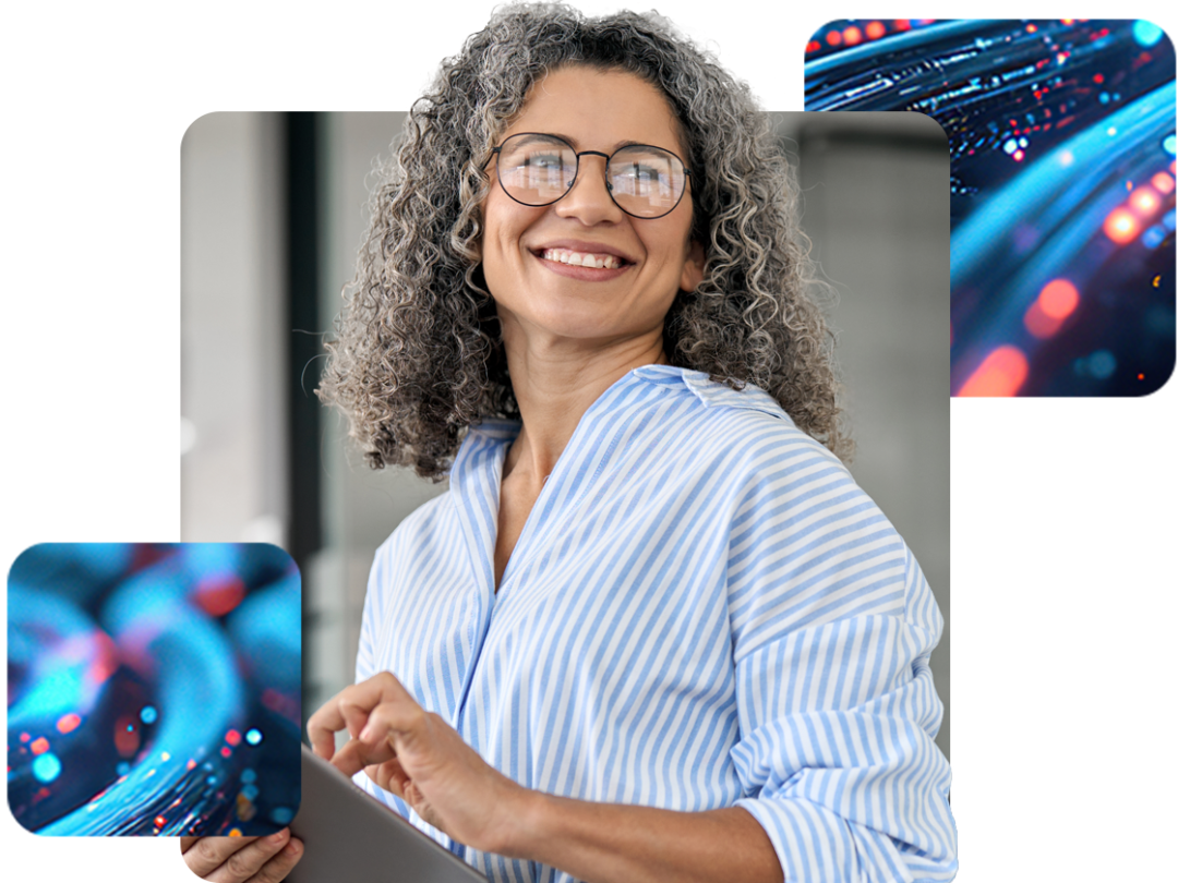 a lady wearing glasses smiling, holding a tablet. Happy about doing her financial reporting with MHR.