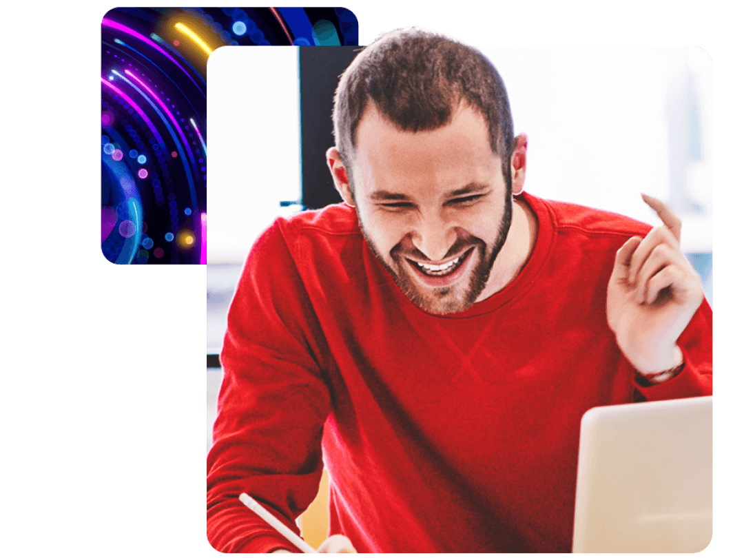 A man sat at a desk laughing, with a laptop in front of him. Discussing MHR's Learning experience platform.