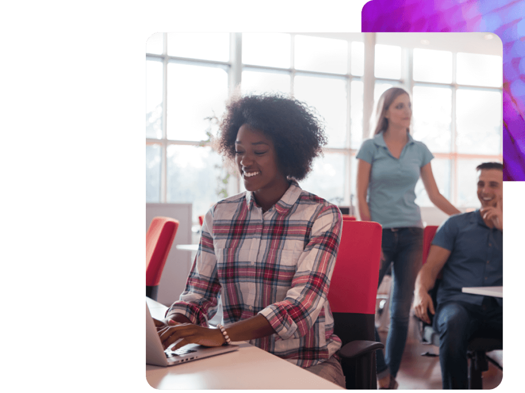 A lady working on a laptop using People Firsts learning experience platform reporting.