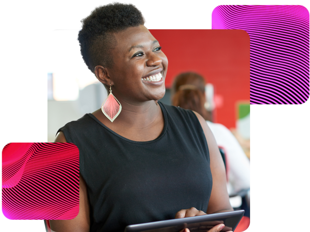 a lady looking up smiling, holding a table in her hands happy after choosing MHR for her reporting and analytics software.