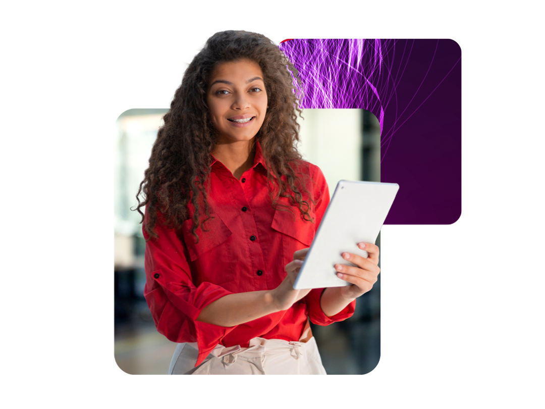 A lady smiling, holding a tablet.