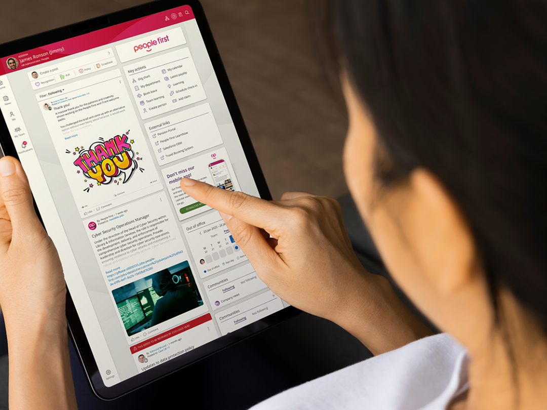 View over the shoulder of a woman viewing People First dashboard on tablet device