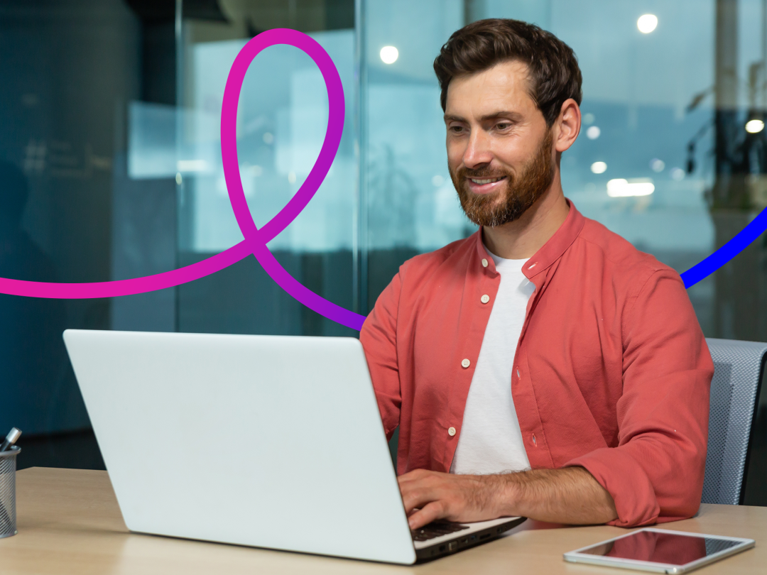Image of a man working on a laptop. 