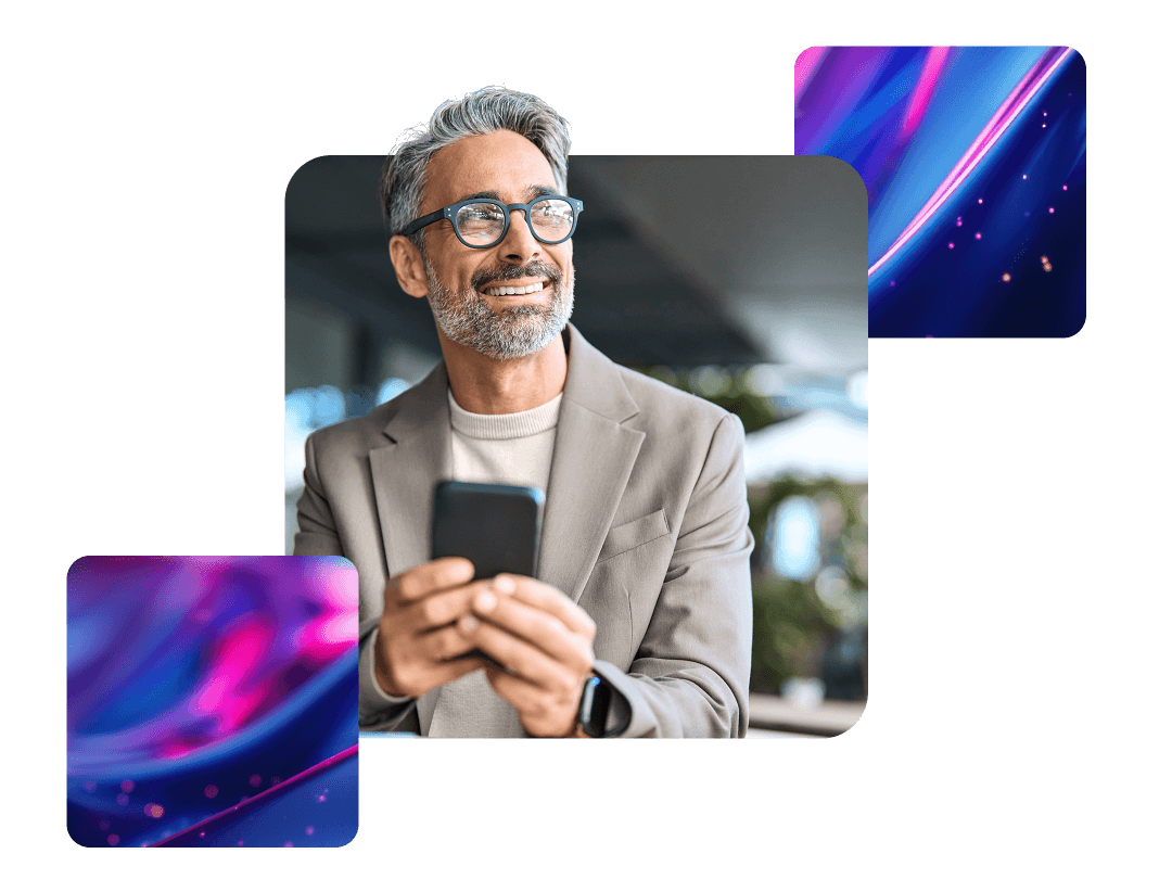 Man holding mobile phone, looking into distance and smiling