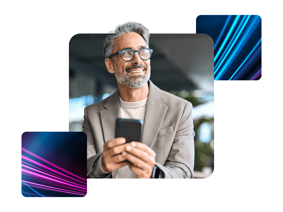 Man with glasses holding his phone