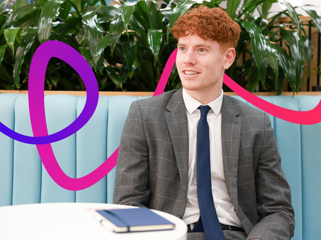 A man sitting on a bench, smiling and notebook 