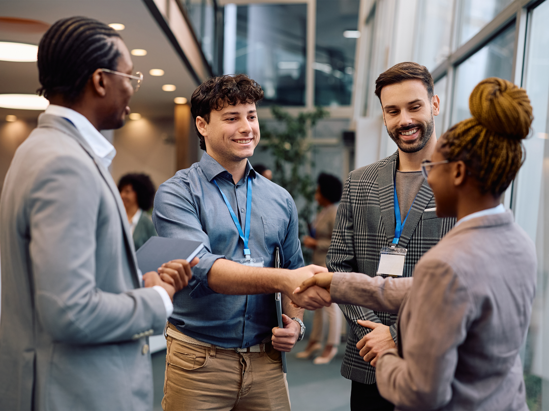 Four people stood talking to one another.