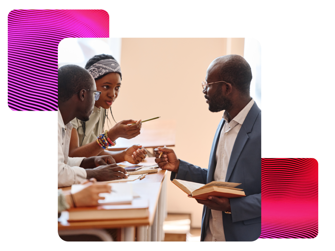 Teacher stood up helping students at their desk asking questions