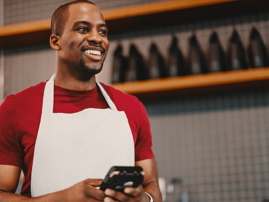 Employee using a mobile device while working in a retail environment
