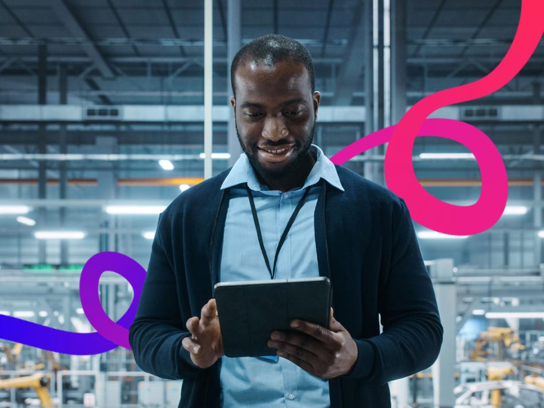 Man stood in a warehouse with an iPad