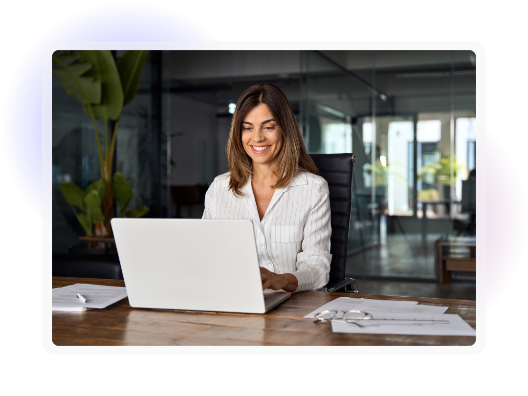 Professional working on a laptop at a desk in an office