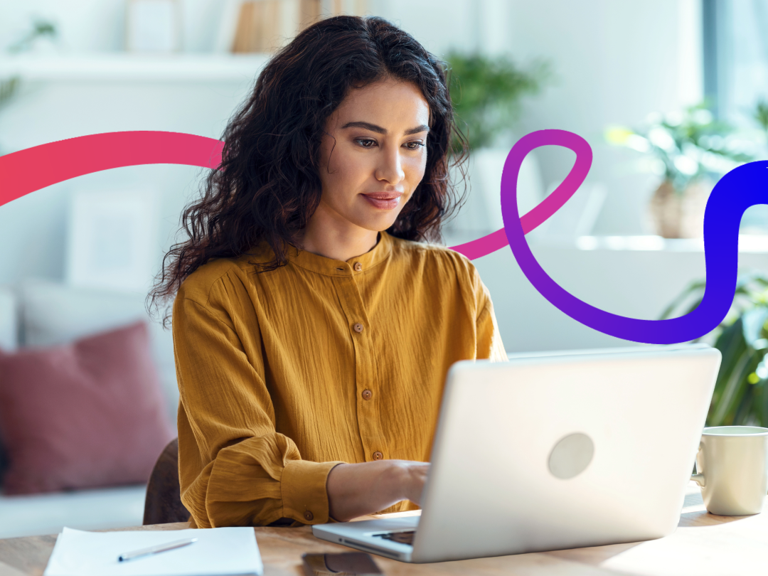 Woman sat at desk typing on laptop