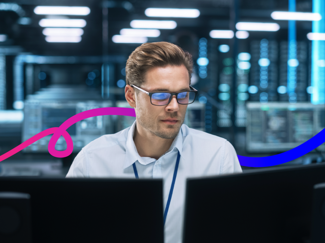 Man sat at desk with two screens