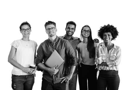 Four people stood together smiling, one holding a laptop.